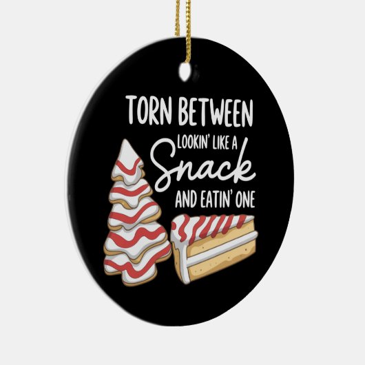 Kerstboomcake verscheurd tussen 'kijken' als een s keramisch ornament (Rechts)