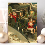 kerstcadeautrein  feestdagenkaart<br><div class="desc">Prachtig oud kersttreinstel briefkaart. De kerstgroeten staan in de linkerbenedenhoek. Dit ontwerp is voorzien van een dirigent van de Santa Claus-trein met twee kleine kinderen die op de voorkant van de trein likken.</div>