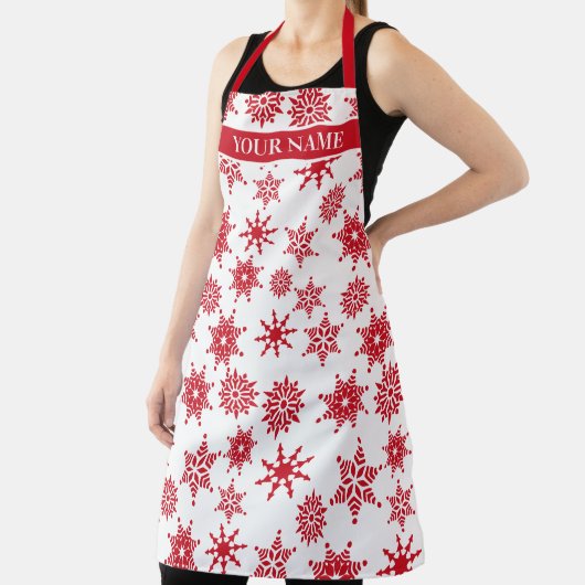 Kerstfeestjes, witte en rode sneeuwvlokken schort (Insitu)
