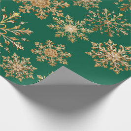 Kerstgoud en groen sneeuwvlokjes inpakpapier