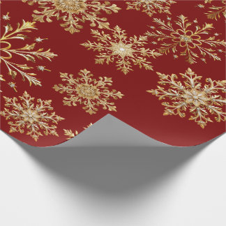 Kerstgoud en rode sneeuwvlokken inpakpapier