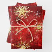Kerstgouden sneeuwvlokken op rode achtergrond inpakpapier vel (In situ)