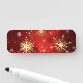 Kerstgouden sneeuwvlokken op rode achtergrond naamplaatje (In situ)