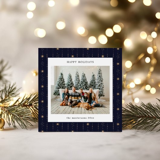 Kerstkaart met blauwe en gouden sterrenbehang foto