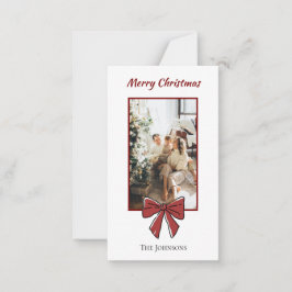 Kerstkaart met rode strik en persoonlijke notitie  notitiekaartje