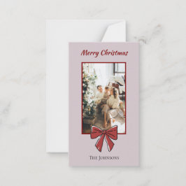 Kerstkaart met rode strik en persoonlijke notitie  notitiekaartje