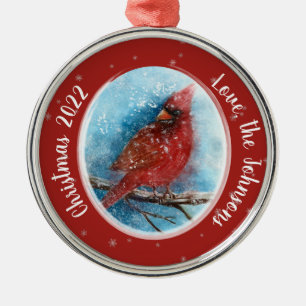 Kerstkardinale sneeuwvlokken op rood of blauw metalen ornament