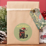 kerstkat ronde sticker<br><div class="desc">Een schattige kat gewikkeld in kerstverlichting, met een kerstmuts aan. De tekst is aanpasbaar. U kunt het wijzigen of zelfs verwijderen. HULP NODIG? Als u hulp nodig heeft met betrekking tot de afbeelding of een verdere aanpassing, laat het me weten door contact met mij op te nemen. (Klik op de...</div>