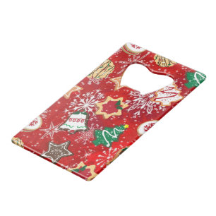 Kerstkoekjes en sneeuwvlokken op rood creditkaart flessenopener
