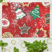 Kerstkoekjes en sneeuwvlokken op rood theedoek (Gevouwen)