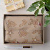 Kerstkoekvormen van gemberkoek op bruin tissuepapier (Geschenk)