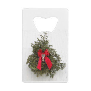 Kerstlint en boom op een schuur creditkaart flessenopener