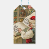 kerstman die werkt op de lijst van Naughty en Nic Cadeaulabel (Voorkant)