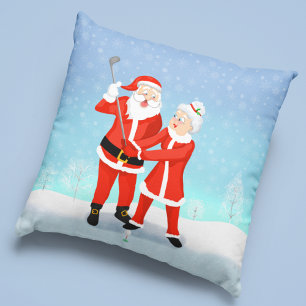 Kerstman helpt mevrouw Claus met haar golfswing Kussen