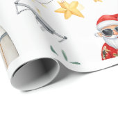 Kerstman met computer en surfplank op kerst cadeaupapier (Rol Hoek)
