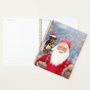 Kerstman met kerstcadeaus rottweiler hond planner