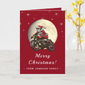 Kerstman op motor rijdt onder maanhemel donkerrood kaart (Gele Bloem)