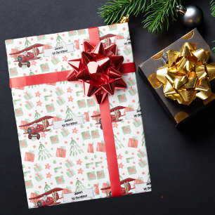Kerstman vliegt in vliegtuig, eerste kerst geperso cadeaupapier