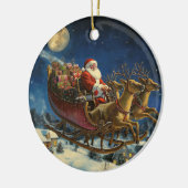 Kerstman vliegt over besneeuwd dorp kerstversierin keramisch ornament (Links)