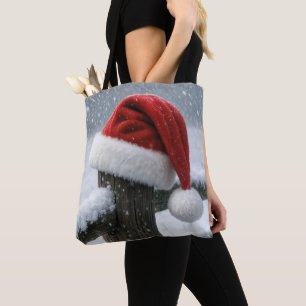 Kerstmannenhoed op een besneeuwde omheiningspaal tote bag