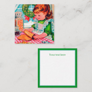kerstmeisje voor het bakken met een rectro notitiekaartje