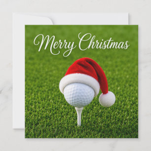 Kerstmis golfen met kerstman hoed op groen gras  kaart