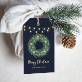 Kerstmis met gouden strijklampjes op blauw cadeaulabel
