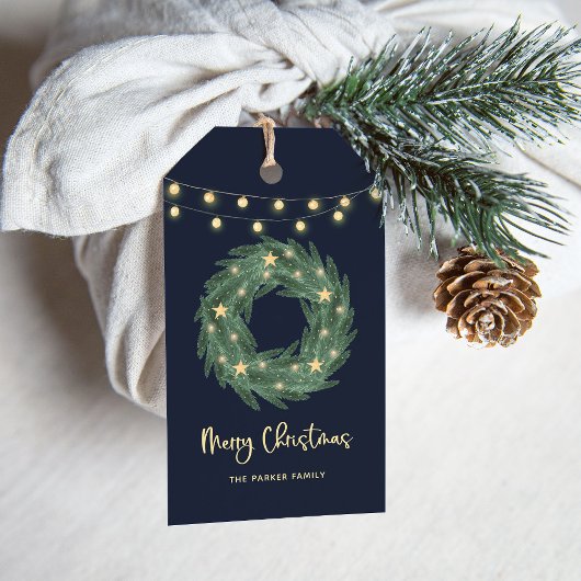 Kerstmis met gouden strijklampjes op blauw cadeaulabel