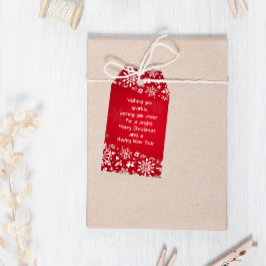 Kerstmis met rode en witte sneeuwvlokken cadeaulabel