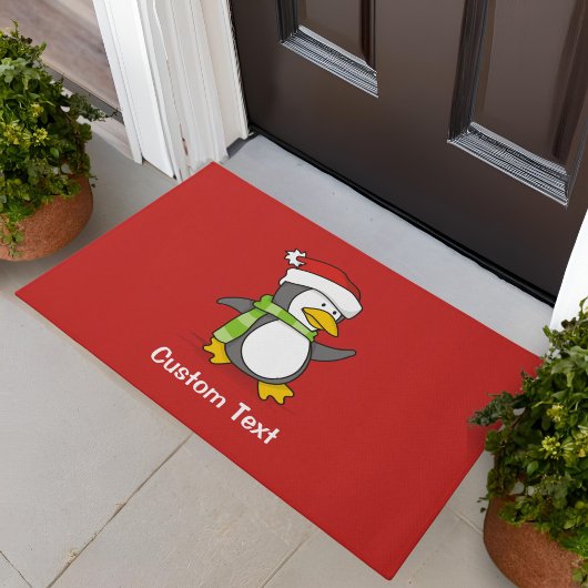 Kerstpinguïn die over sneeuw loopt deurmat