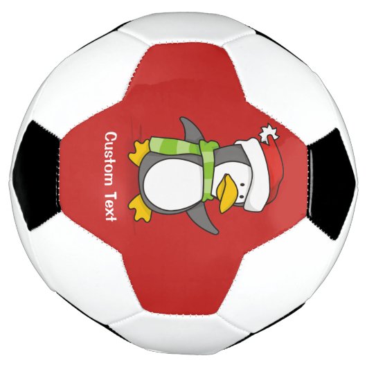 Kerstpinguïn loopt op sneeuw voetbal (Gedraaid)