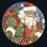 KERSTSPEELGOED RONDE STICKER<br><div class="desc">Deze Victoriaans kerstman met zijn krans en teddybeer komt overeen met het wenskaart CHRISTMAS TOYS.</div>
