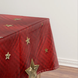Kerststerren van namaakmetaal in rood en goud tafelkleed