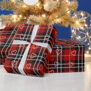 Kerststokharten en sneeuwvlokken op geruit cadeaupapier