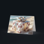 Kerststrandcadeau met zeesterren kaart<br><div class="desc">Een prachtig verpakte kerstcadeaudoos versierd met zeesterren en zeeschelp decoraties zit op een zandstrand,  met een turquoise oceaan en wazige lichten op de achtergrond</div>