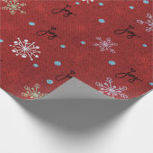 Kerstvreugde en sneeuwvlokken op rood cadeaupapier (Hoek)