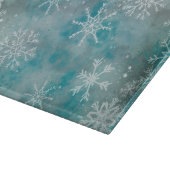 Kerstwinterwitte sneeuwvlokken op blauw snijplank (Hoek)