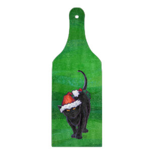 Kerstzwarte kat op groen snijplank