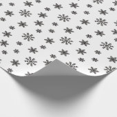 Kerstzwarte sneeuwvlokken op witte achtergrond cadeaupapier (Hoek)