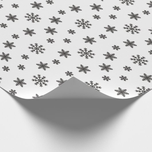 Kerstzwarte sneeuwvlokken op witte achtergrond cadeaupapier (Hoek)