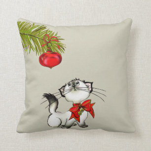 Keukenkat in een rode kerstbak kussen