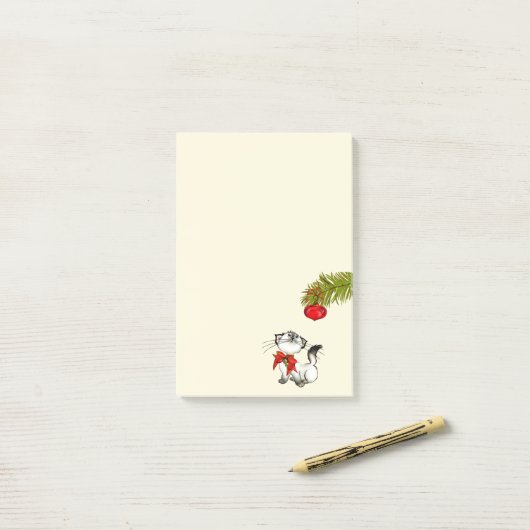 Keukenkat in een rode kerstbak post-it® notes (Op bureau)