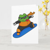 Kikker als sneeuwsurfer met snowboard kaart (Gele Bloem)