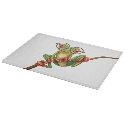 Kikte groene kikker met oogbril op wit snijplank (Hoek)