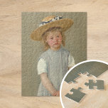 Kind in een Pet met riem | Mary Cassatt Legpuzzel<br><div class="desc">Kind in een Pet van de straat (1886) door de Amerikaanse impressionist Mary Cassatt. Origineel kunstwerk is een oliesschilderij op doek dat een portret van een jong meisje in een overmaats rietje pet toont, met een platte grijze pinaderij. De serieuze expressie op het gezicht van het meisje maakt dit schilderij...</div>