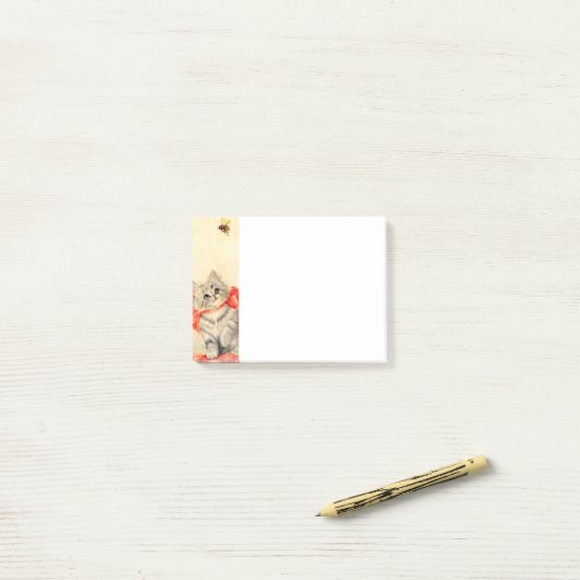 Kitten met een rood lint post-it® notes (Op bureau)