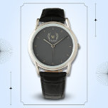 Klassieke laurel krans zwart goud monogram horloge<br><div class="desc">Een klassiek laurierkransontwerp in zwart en goud,  wat een perfecte mix van charme en elegantie geeft. Het monogram voegt een speciaal tintje toe. Ideaal als gepersonaliseerd cadeau voor familie en vrienden</div>