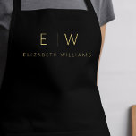 Klassieke Zwart Goud Minimalistische Monogram Naam Schort<br><div class="desc">Verhoog uw culinaire ervaring met onze Classic Elegant Modern Minimalist Monogram Name Cooking Schort. Deze essentiële keuken combineert tijdloze elegantie naadloos met hedendaags minimalisme. Dit schort is met precisie vervaardigd en is niet alleen een praktisch accessoire, maar ook een uiting van persoonlijke stijl. Met het aanpasbare monogram en de naamoptie...</div>