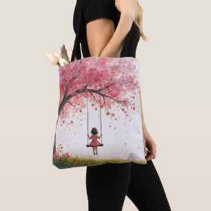 Klein meisje op een kersenboom schommel tote bag