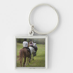 Kleine meisjes die met paarden rijden sleutelhanger